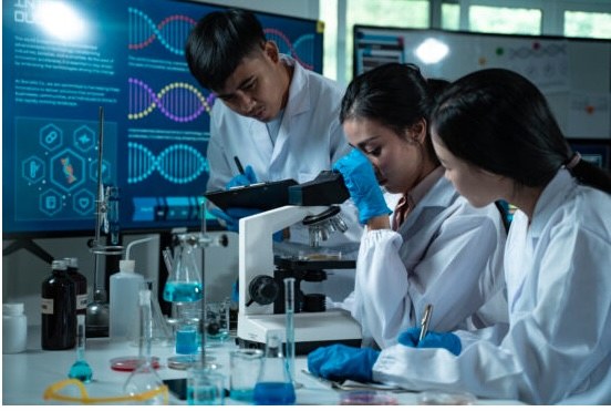 Researchers working at a microscope in a laboratory